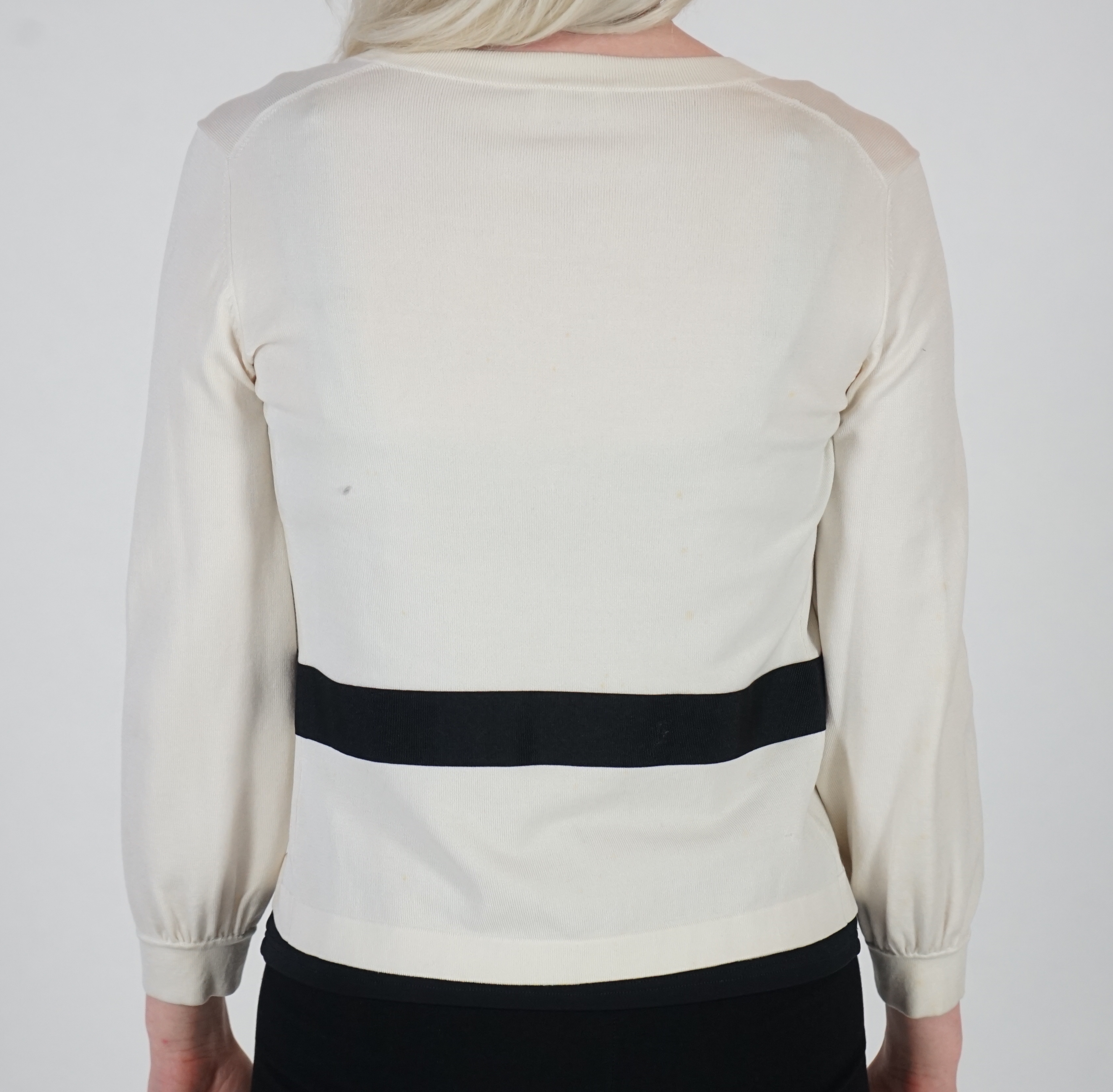 A white Valentino jacket with black camisole